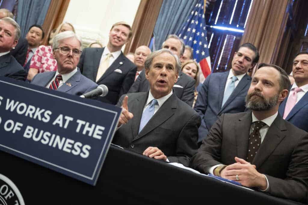 1. Group of professionals at Texas Bullpen business event in a formal meeting setting.