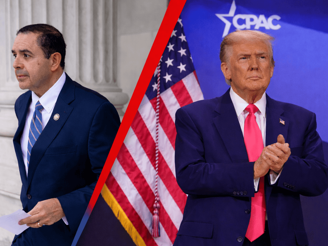 Man in suit at political event with American flag, CPAC background.
